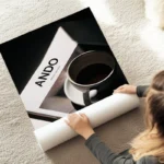 poster tasse blanche sur livre au sol.webp