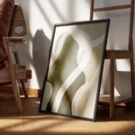 affiche abstraite aux formes vertes et beiges avec des lignes blanches et une te encadre.webp