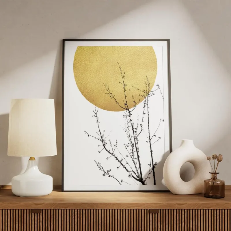 affiche abstraite avec un soleil dore et des branches darbuste noires typographi meuble.webp