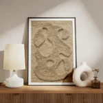 affiche abstraite beige avec des formes organiques texturees sur un fond tricote meuble.webp