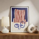 affiche abstraite dun visage bleu minimaliste avec un chapeau a rayures rouges e meuble.webp