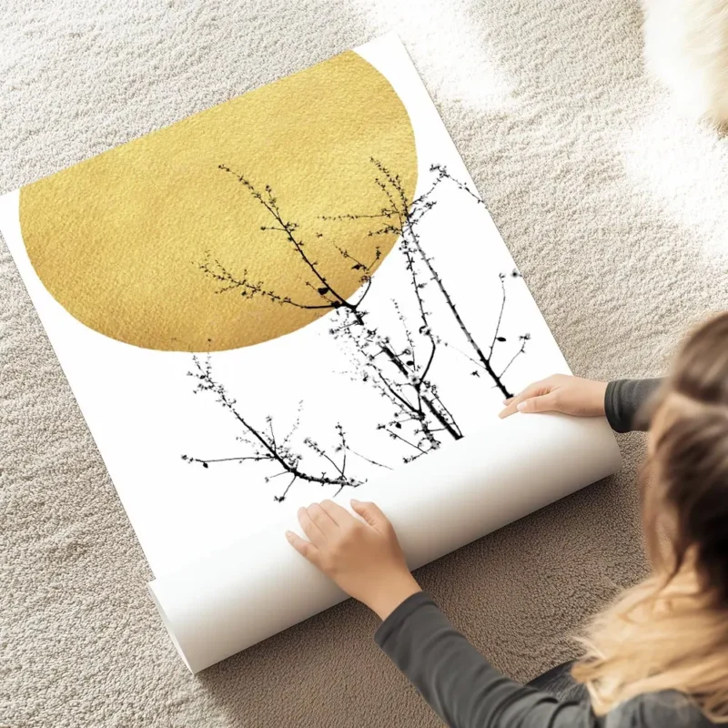 affiche abstraite avec un soleil dore et des branches darbuste noires typographi au sol.webp