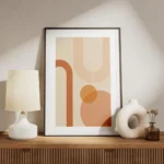 affiche aux formes geometriques orange et peche sur fond beige avec bordure blan meuble.webp