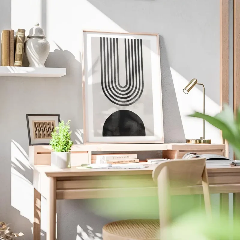 affiche avec arche abstraite en noir composee de lignes et forme noire sur fond bureau.webp