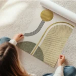 affiche avec cercle et arche dores lignes noires et forme verte sur fond beige en rouleau.webp