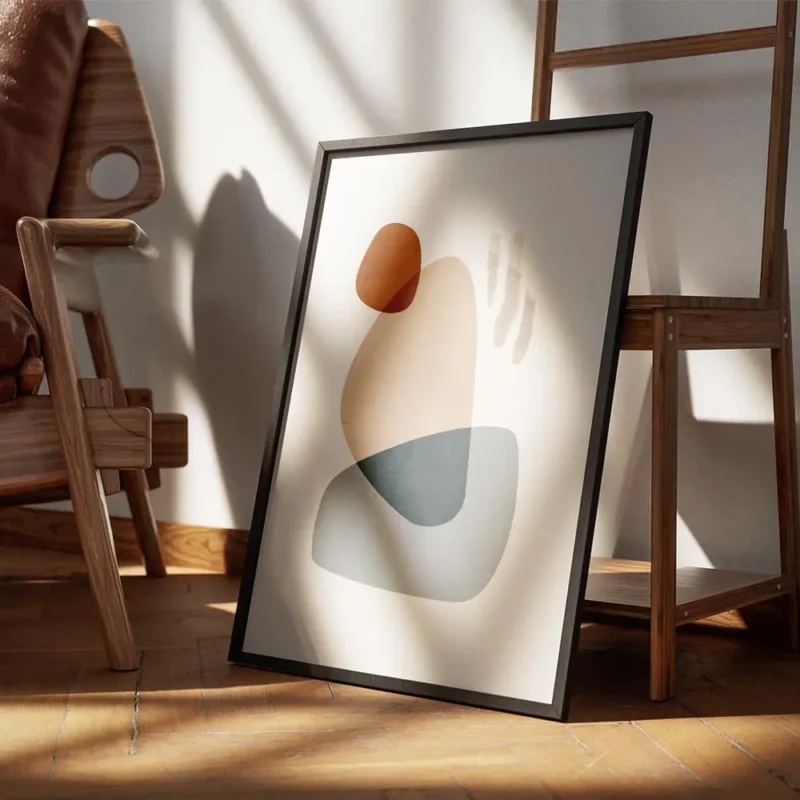 affiche avec des formes abstraites en gris bleu beige et marron sur un fond clai encadre.webp