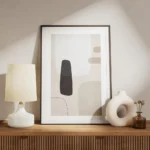 affiche avec des formes abstraites en noir gris clair et beige sur un fond beige meuble.webp
