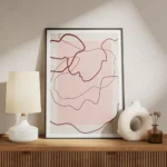 affiche avec des lignes abstraites rouges sur un fond rose clair et beige creant meuble.webp