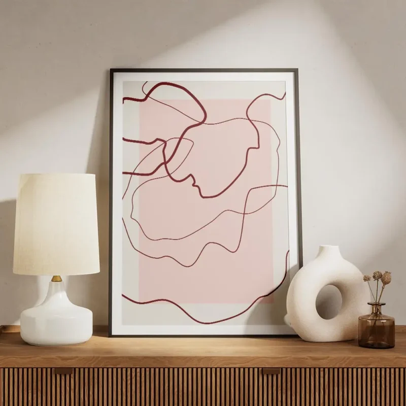 affiche avec des lignes abstraites rouges sur un fond rose clair et beige creant meuble.webp