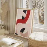 affiche avec des lignes epaisses abstraites rouges roses et noires entrelacees s salon beige.webp