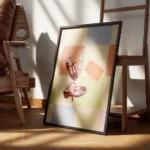 affiche avec deux chaussures bordeaux un verre de vin blanc et un livre sur un f encadre.webp