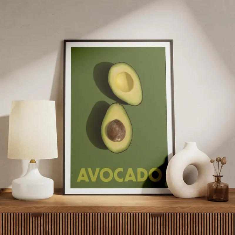 affiche avec deux moities davocat sur un fond vert fonce le texte avocado en bas meuble.webp