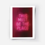 affiche avec enseigne au neon rose fonce this must be the place sur fond sombre .webp
