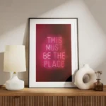 affiche avec enseigne au neon rose fonce this must be the place sur fond sombre meuble.webp