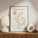 affiche avec formes abstraites beiges et contour dore typographie noire sur fond meuble.webp