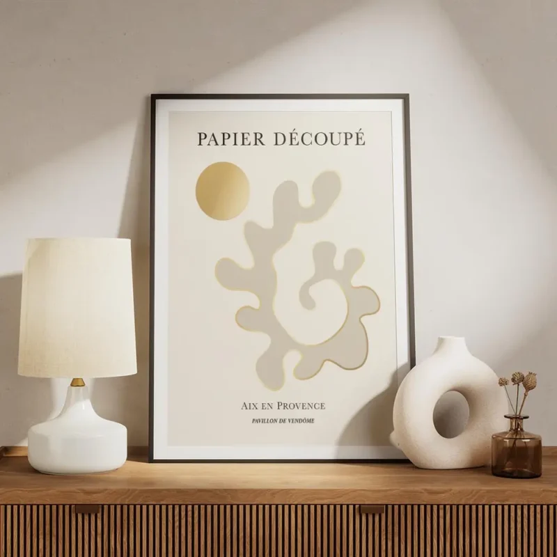 affiche avec formes abstraites beiges et contour dore typographie noire sur fond meuble.webp