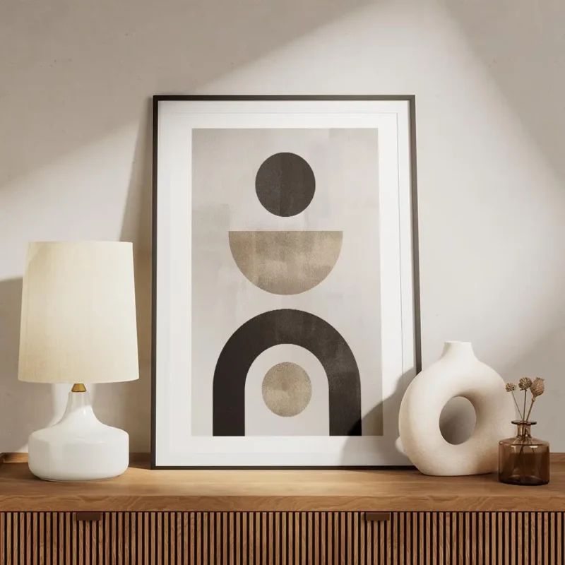 affiche avec formes abstraites noires et beiges sur fond gris beige typographie meuble.webp