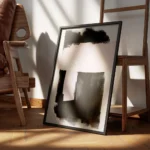 affiche avec formes abstraites noires et roses peintes a laquarelle sur fond gri encadre.webp