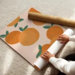 affiche avec illustration de plusieurs oranges et feuilles vertes sur fond clair enroule.webp