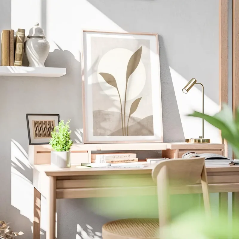 affiche avec illustration dun soleil blanc derriere des feuilles beiges sur un f bureau.webp