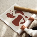 affiche avec illustration graphique rouge et beige dun visage abstrait et dune m enroule.webp