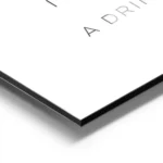 affiche avec le texte you look like i need a drink en typographie noire fine sur aluminium.webp