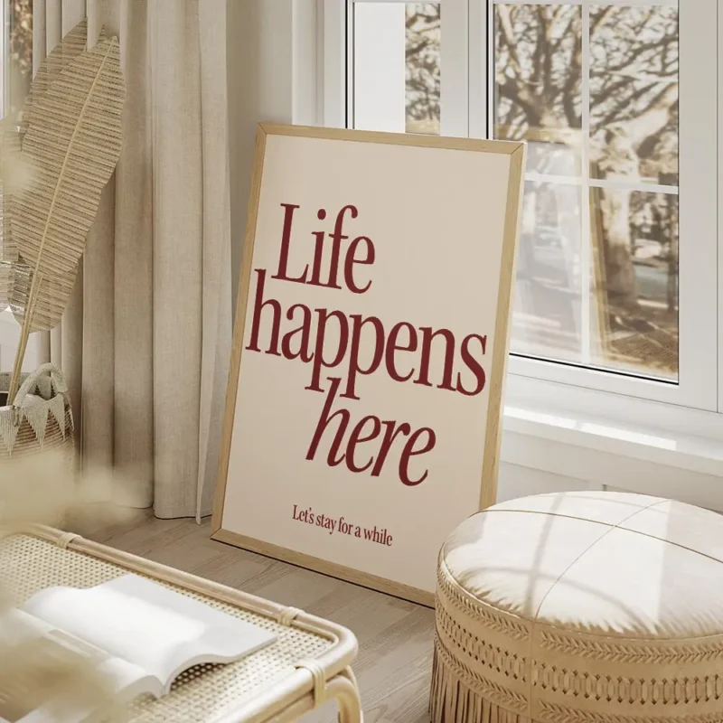 affiche avec linscription life happens here en rouge fonce et lets stay for a wh salon beige.webp