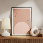 affiche avec lune rose pale et ciel rose des oiseaux noirs volent sur fond clair meuble.webp