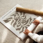 affiche avec motif de feuille abstraite marron et texte typographie noir sur fon enroule.webp