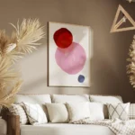 affiche avec trois formes rondes aux teintes vives rouge rose et bleu fonce sur salon.webp