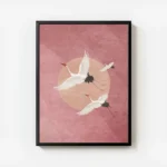affiche avec trois grues blanches volantes sur un fond rose avec un cercle peche avec cadre.webp