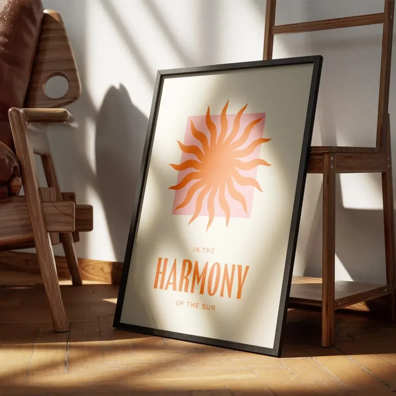 affiche avec un soleil orange sur un carre rose et le texte in the harmony of th encadre.webp