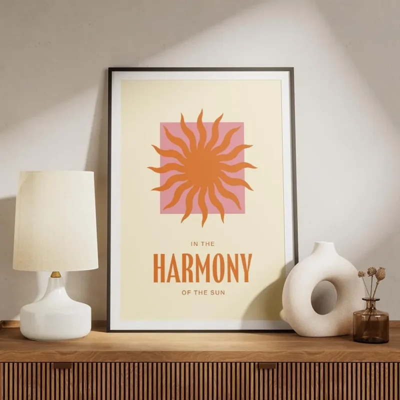 affiche avec un soleil orange sur un carre rose et le texte in the harmony of th meuble.webp