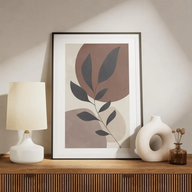 affiche avec une branche grise a feuilles devant des cercles lilas et marron sur meuble.webp