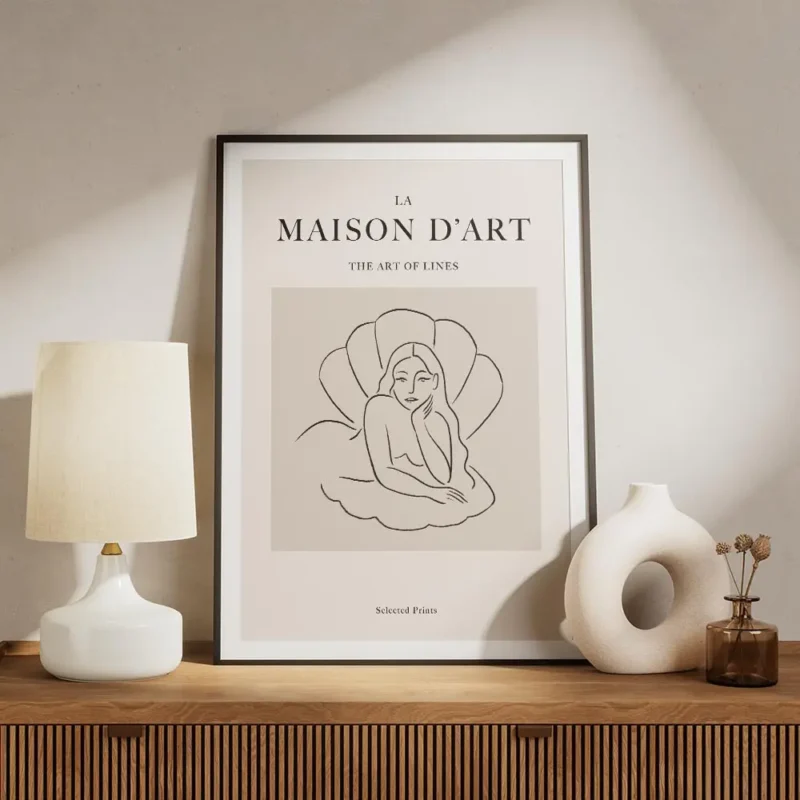 affiche avec une femme allongee dans un coquillage en line art noir sur fond bei meuble.webp