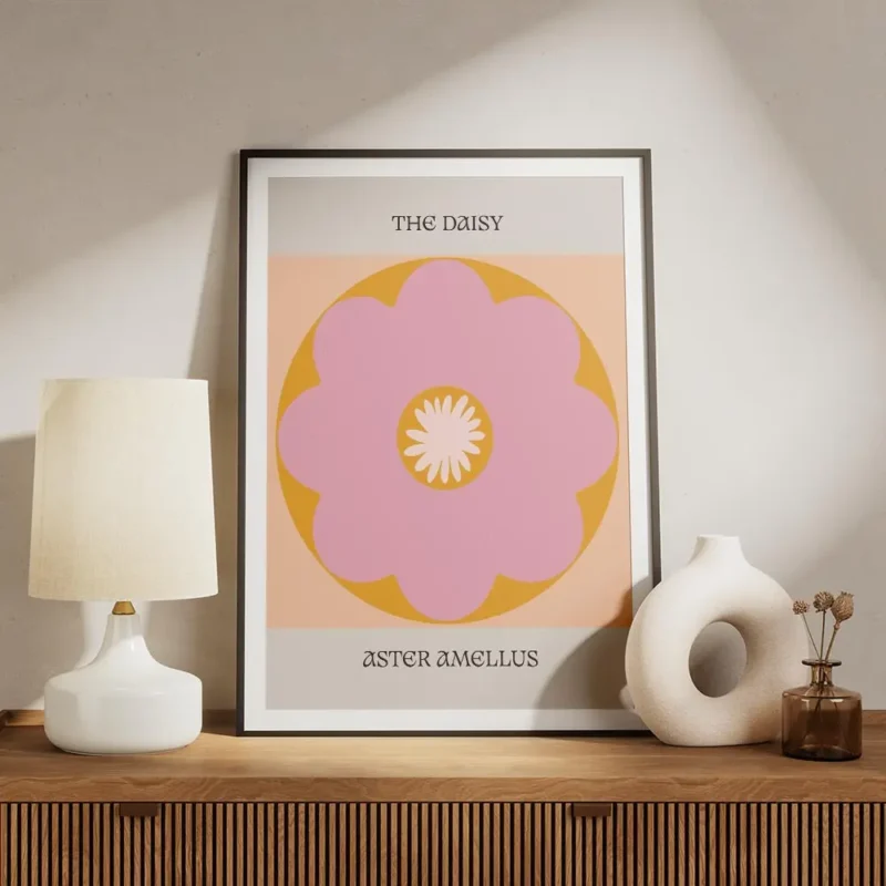 affiche avec une fleur marguerite rose et orange a la typographie the daisy et a meuble.webp