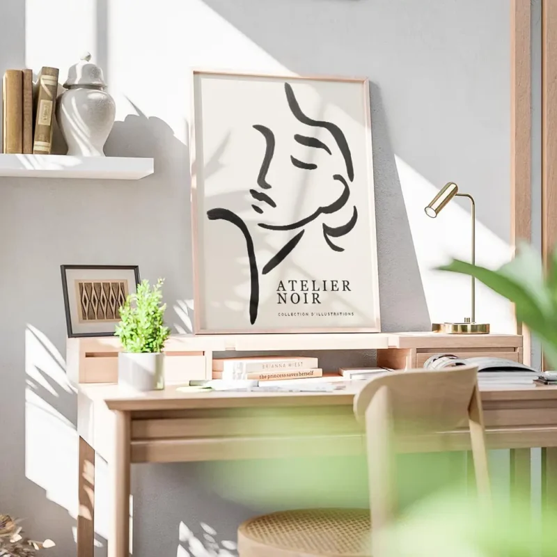 affiche avec une illustration de line art dun visage feminin abstrait en noir su bureau.webp