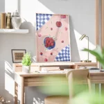 affiche avec une nature morte de cerises rouges et de petales sur une nappe rose bureau.webp