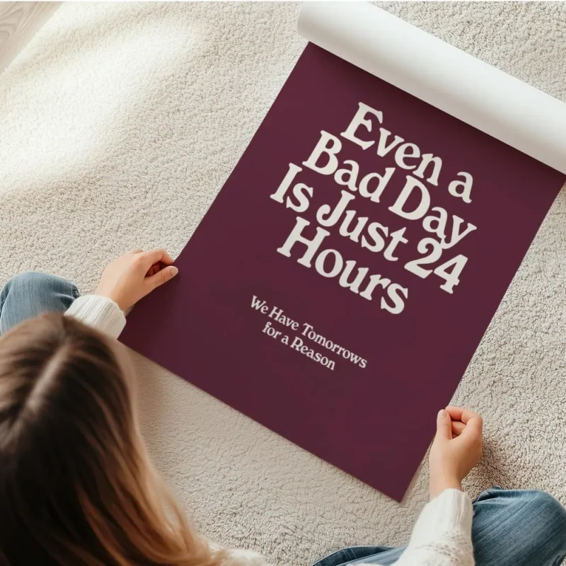 affiche bad day avec typographie blanche sur fond bordeaux presentant une citati en rouleau.webp