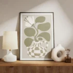 affiche bold flower une fleur blanche stylisee avec des feuilles vertes dans un meuble.webp
