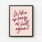 affiche citation rose avec le texte woke up sexy as hell again en typographie ro avec cadre.webp