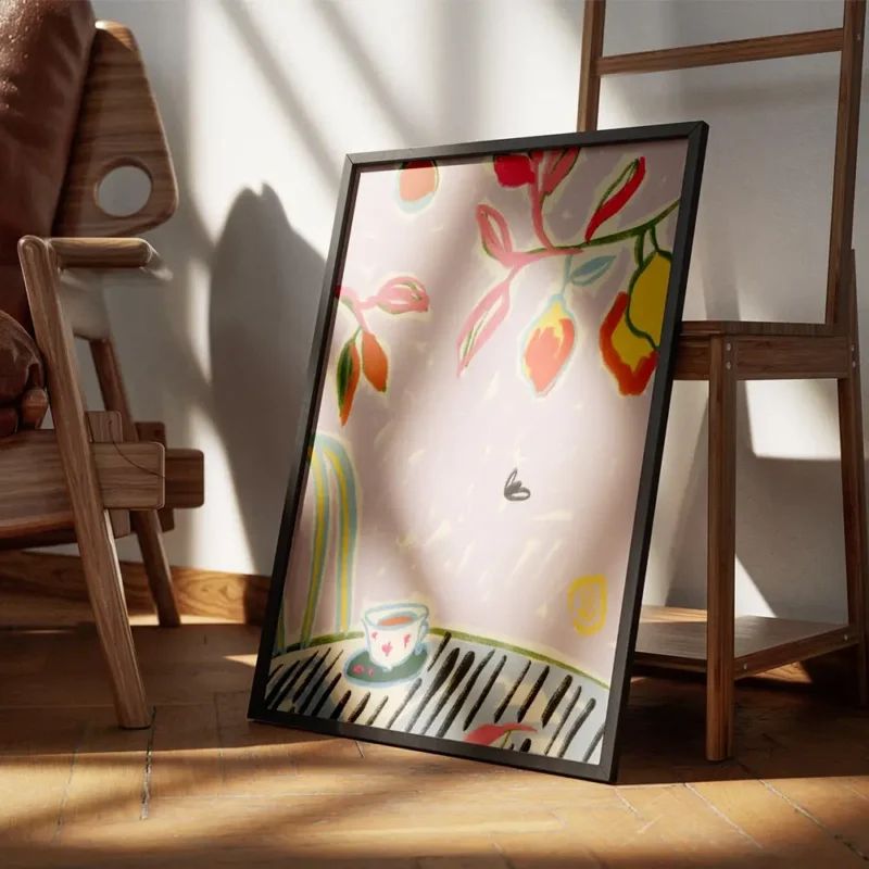 affiche coloree avec tasse de cafe sur une table feuillage vert et rose et fruit encadre.webp