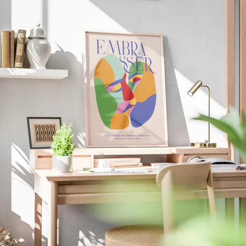 affiche coloree montrant deux visages abstraits sembrassant avec le mot embaasse bureau.webp