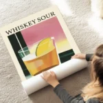 affiche de cocktail whiskey sour avec une tranche de citron et du texte typograp au sol.webp