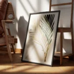 affiche de deux feuilles de palmier une doree et une verte sur un fond en pierre encadre.webp