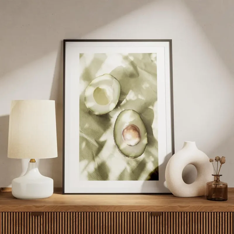 affiche de deux moities davocat sur papier vert avec des ombres creant des motif meuble.webp