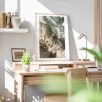 affiche de feuilles de monstera une verte et une doree sur un fond beige avec un bureau.webp